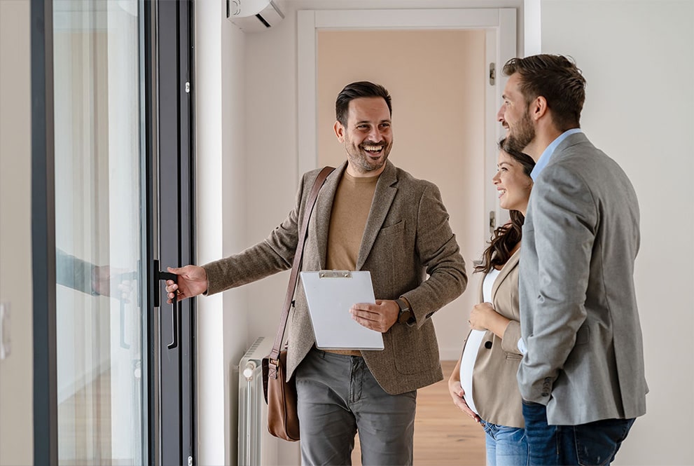 Man introducing couple to a new home